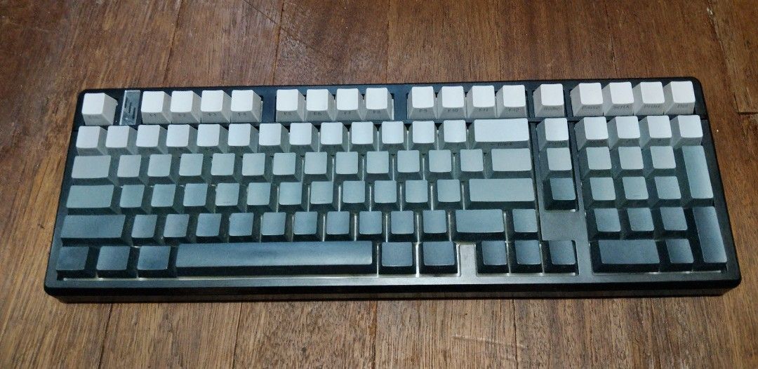 Dark Alien K102 Mechanical Keyboard (Category: Computer Keyboard) located in Manila. Submitted by boyhet.thrift15 (Listing ID 1466228090, Image 1). Description: - Model: Dark Alien K102 Mechanical Keyboard - Layout: 102 keys with full numeric keypad - Aesthetics: White-to-dark-grey gradient keycaps with vibrant green backlighting - Connectivity: Type-C port, USB connection switch, and wireless mode toggle on the back - Build: Clean bottom plate e
