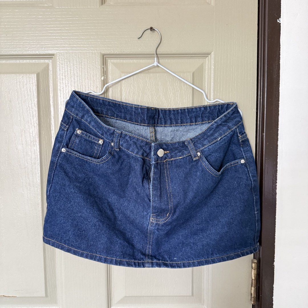 Dark blue denim mini skirt (Category: Skirts) located in Angeles City. Submitted by elliemnopqrstuv (Listing ID 1466205668, Image 1). Description: - Color: Dark blue - Style: Denim mini skirt - Closure: Front button with zipper fly - Pockets: Two functional front pockets with silver rivet details - Details: Classic contrast stitching - Fit: Short length, versatile casual staple Rfs: too big on me.