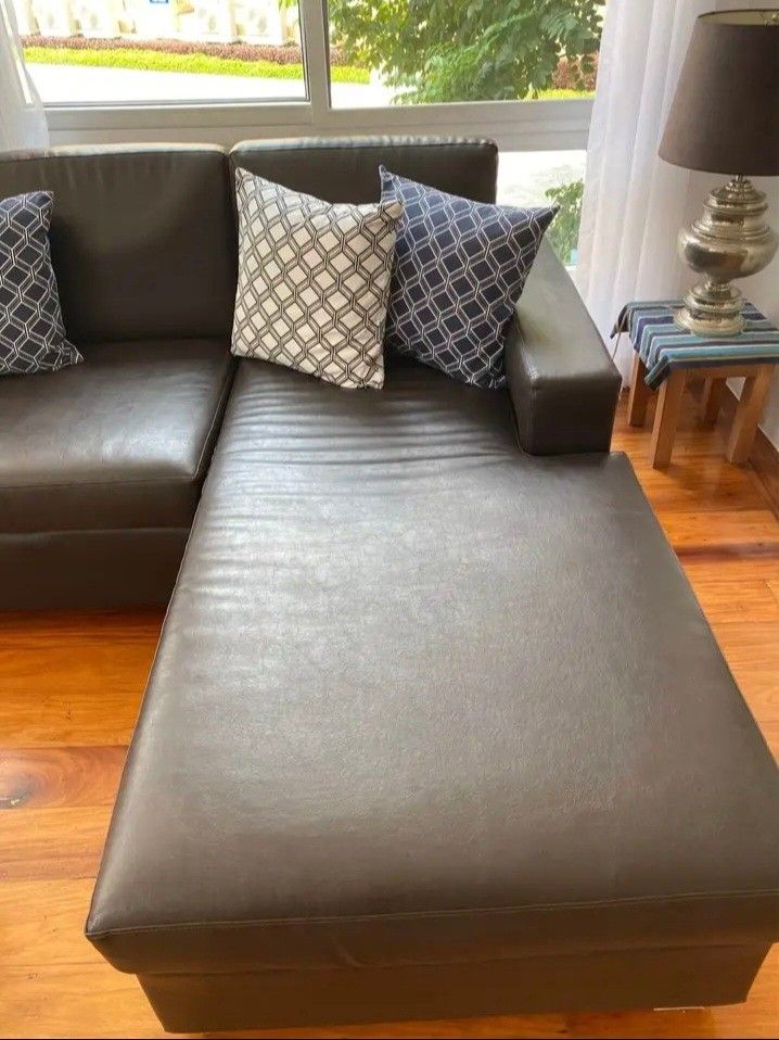 Dark brown leather L-shape sectional sofa with decorative pillows (Category: Sofas) located in Paranaque City. Submitted by nicessities (Listing ID 1466336303, Image 2). Description: - Dark brown leather sectional sofa with right-side chaise lounge - Extra spacious seating for family and guests - Premium comfort, great for living rooms - well used. ready for pickup NOTE: buyer to arrange pick up including people who'll carry. no one to carry in t