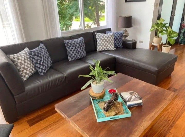 Dark brown leather L-shape sectional sofa with decorative pillows (Category: Sofas) located in Paranaque City. Submitted by nicessities (Listing ID 1466336303, Image 1). Description: - Dark brown leather sectional sofa with right-side chaise lounge - Extra spacious seating for family and guests - Premium comfort, great for living rooms - well used. ready for pickup NOTE: buyer to arrange pick up including people who'll carry. no one to carry in t