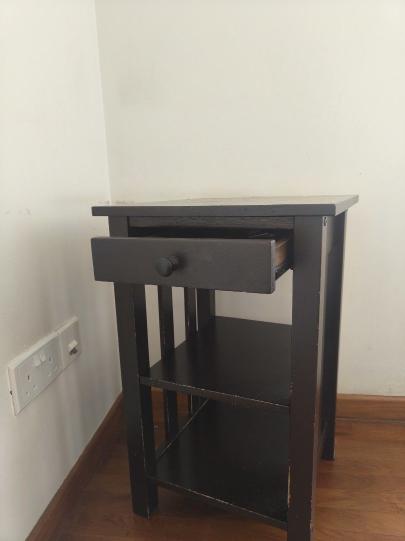 Side table (Category: Shelves, Cabinets & Racks) located in Singapore. Submitted by minml (Listing ID 1466201994, Image 3). Description: - Dark brown solid wood side table - 1 pull-out drawer with a black knob - 2 open lower shelves - Dimensions: height 61cm, 38cm x 38cm - side edges paint wear off. - pick up balestier/toa payoh.
