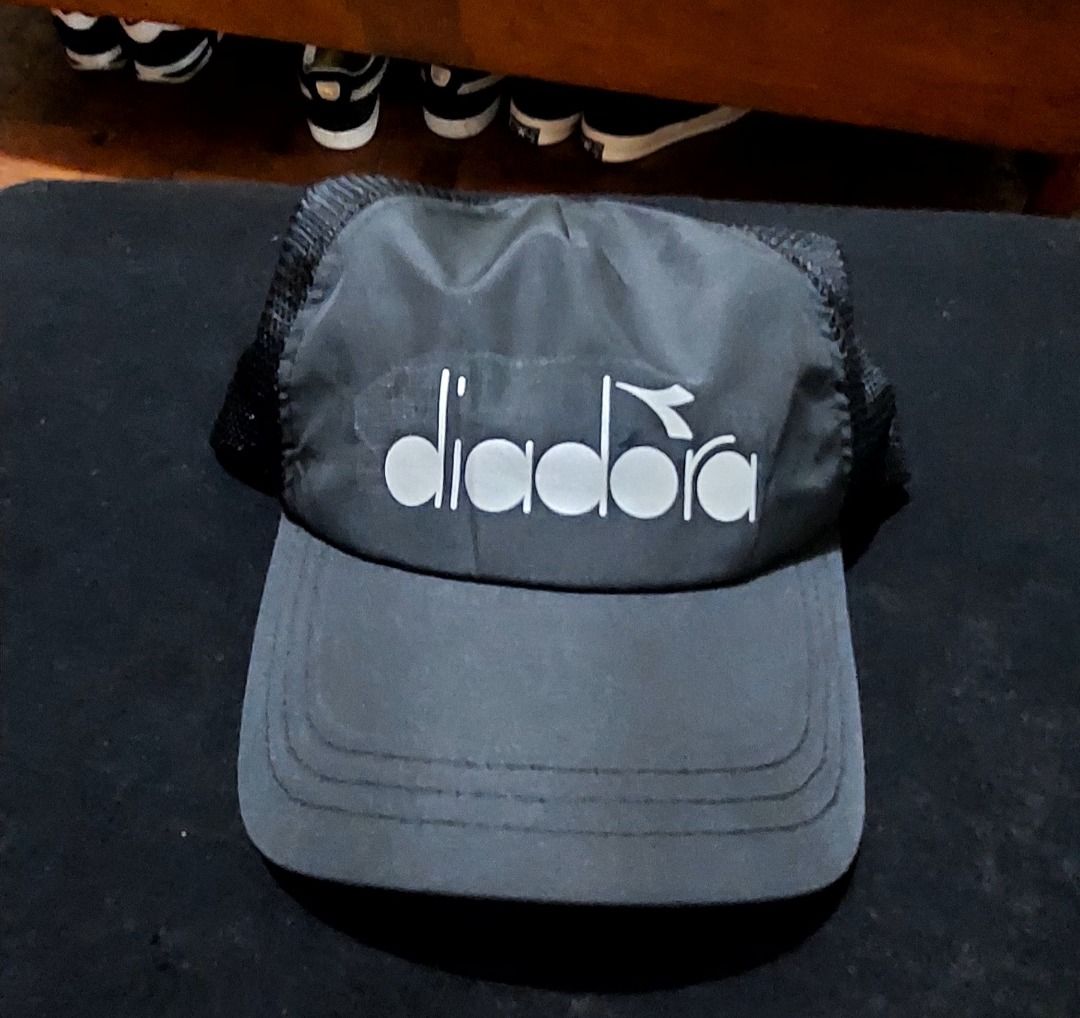 Diadora Black Trucker Cap Hat (Category: Caps & Hats) located in Legazpi City. Submitted by street_uniform (Listing ID 1466315294, Image 1). Description: - Brand: Diadora - Color: Classic Black with Bold White Logo - Design: Curved brim with breathable mesh back panels - Fit: Adjustable strap for a custom fit - Style: Versatile everyday hat perfect for sports or casual wear.