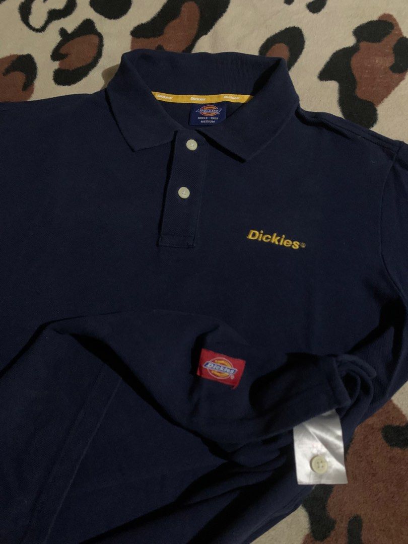 Dickies Navy Blue Polo Shirt Medium (Category: Tshirts & Polo Shirts ) located in Baguio. Submitted by ISO_PRINCE (Listing ID 1466312136, Image 3). Description: - Brand: Dickies - Color: Navy Blue - Size: Medium - Details: Yellow embroidered logo on chest, classic collar with 2 white buttons, small red woven tag near hem, yellow branded inner neckline taping - Condition: Excellent / Good as new - Style: Casual streetwear, easy to pair with jeans 