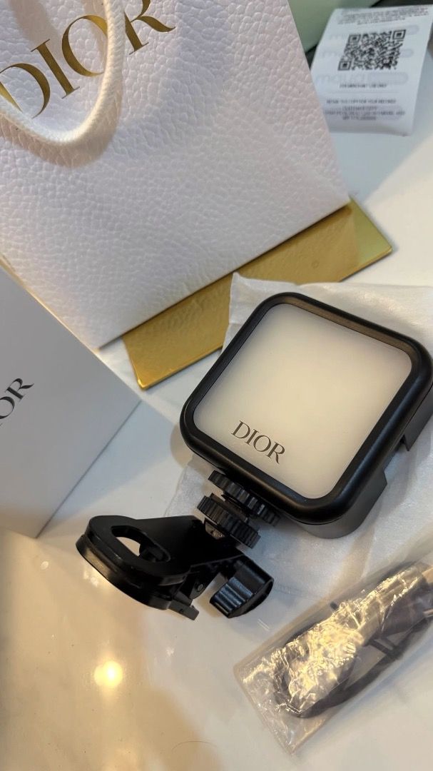 Dior Portable LED Selfie Light Clip-on Ring Light (Category: Makeup) located in Makati City. Submitted by mariaasevilla0622eb (Listing ID 1466284631, Image 2). Description: - Brand: Dior portable LED selfie light - Features: Adjustable brightness modes and color temperatures - Compatibility: Easily clips onto smartphones and other devices - Charging: Rechargeable via included USB-C cable - Packaging: Comes complete with original Dior gift box, pa