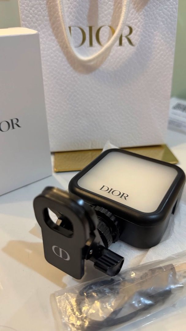 Dior Portable LED Selfie Light Clip-on Ring Light (Category: Makeup) located in Makati City. Submitted by mariaasevilla0622eb (Listing ID 1466284631, Image 3). Description: - Brand: Dior portable LED selfie light - Features: Adjustable brightness modes and color temperatures - Compatibility: Easily clips onto smartphones and other devices - Charging: Rechargeable via included USB-C cable - Packaging: Comes complete with original Dior gift box, pa