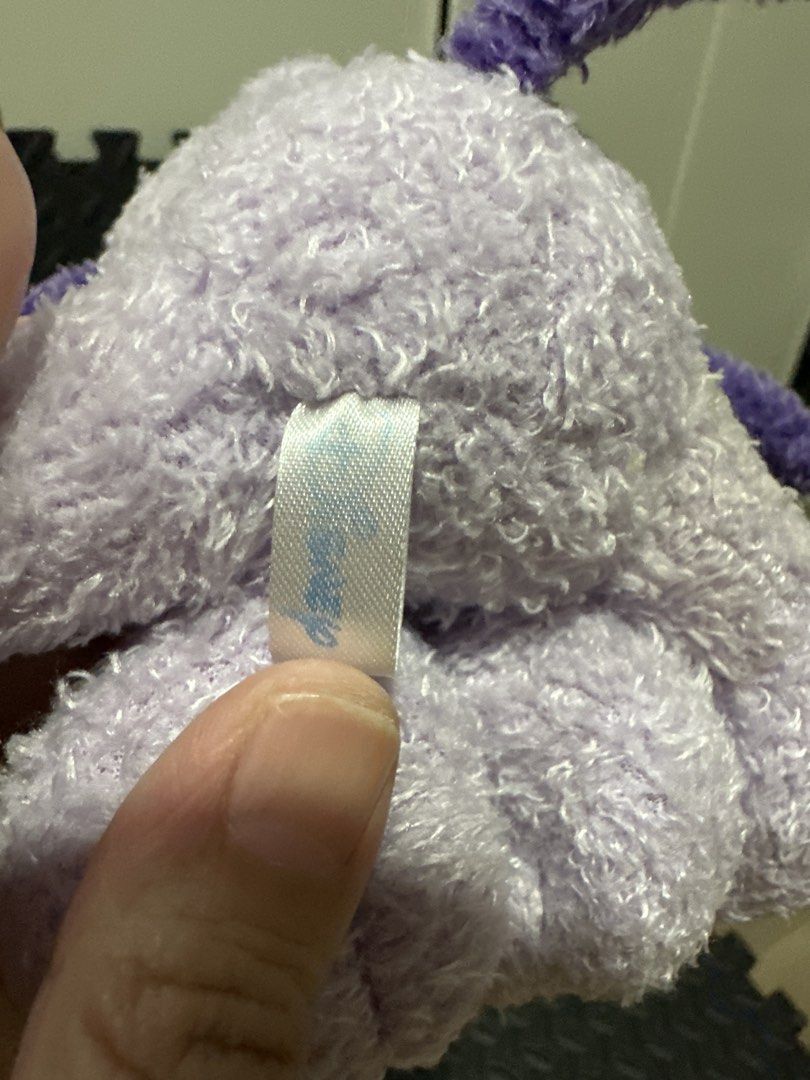 Disney Purple Pluto Dog Plush Toy (Category: Plushies & Soft Toys) located in Cainta. Submitted by shopbyyna (Listing ID 1466262463, Image 3). Description: - Official Disney Pluto plush toy in a rare purple color - Super soft, fuzzy texture with a sitting pose - Features cute embroidered Pluto name and bone graphic on the foot paw - Original tag intact (United International LTD, Made in China, Disney) - Clean fabric, very fluffy, and well-maintai