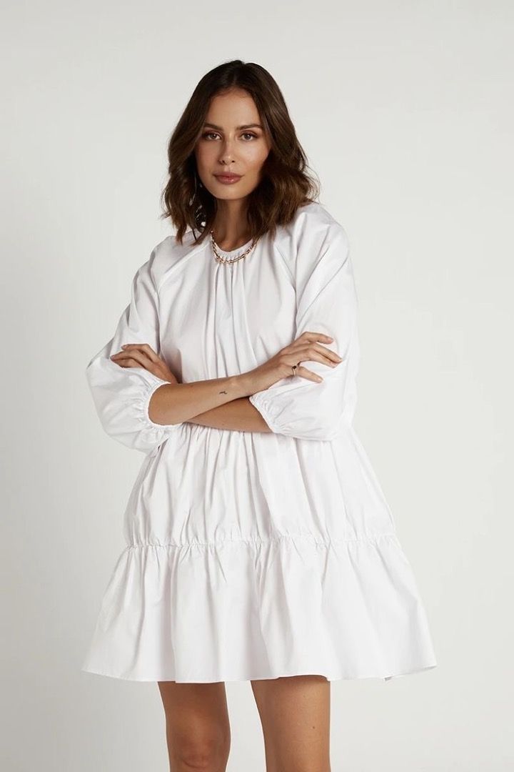 DISSH Milly Cotton White Mini Dress (Category: Dresses) located in Caloocan City. Submitted by demialma (Listing ID 1466240419, Image 2). Description: Size: XS (could fit up to Small) Color: White 100% cotton poplin fabrication - Babydoll mini dress - Relaxed fit - High round neckline - Long puff sleeves with elastic cuff - Drop tier frill design with elasticated gathering - Keyhole back with button closure.