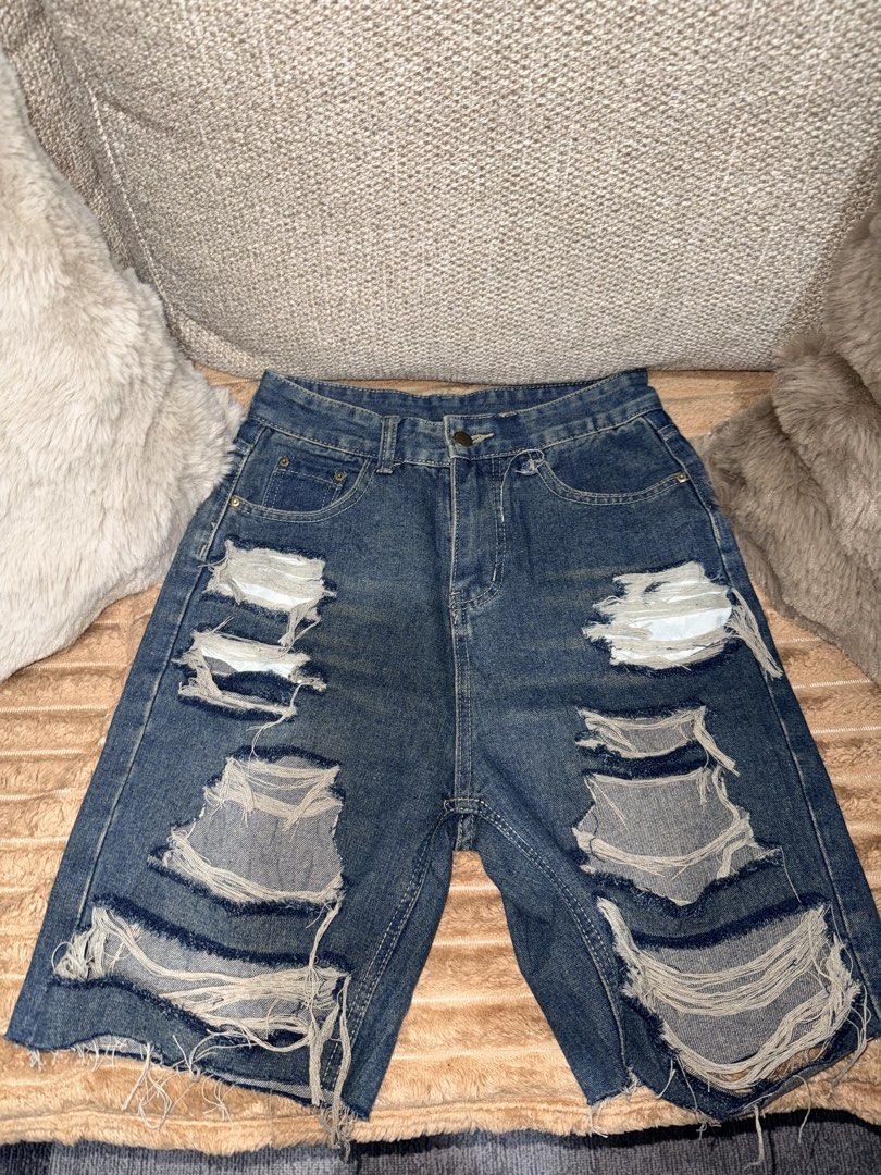 Distressed Blue Denim Shorts (Category: Shorts) located in Manila. Submitted by hpshop2020 (Listing ID 1466177015, Image 2). Description: - Wash: Medium dark blue - Details: Heavy distressing on the front with raw, frayed hems - Fit/Style: Classic five-pocket design with belt loops - Closure: Button fly - Condition: Excellent pre-loved condition with back pocket sizing tag intact 200only.