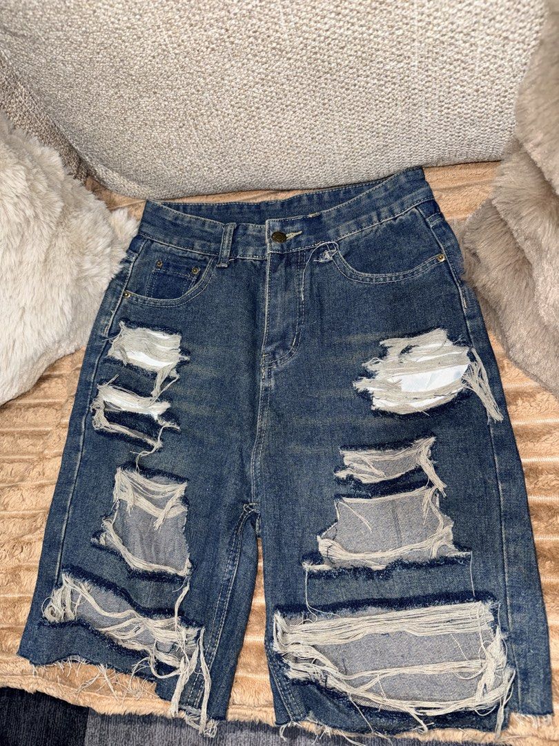 Distressed Blue Denim Shorts (Category: Shorts) located in Manila. Submitted by hpshop2020 (Listing ID 1466177015, Image 1). Description: - Wash: Medium dark blue - Details: Heavy distressing on the front with raw, frayed hems - Fit/Style: Classic five-pocket design with belt loops - Closure: Button fly - Condition: Excellent pre-loved condition with back pocket sizing tag intact 200only.