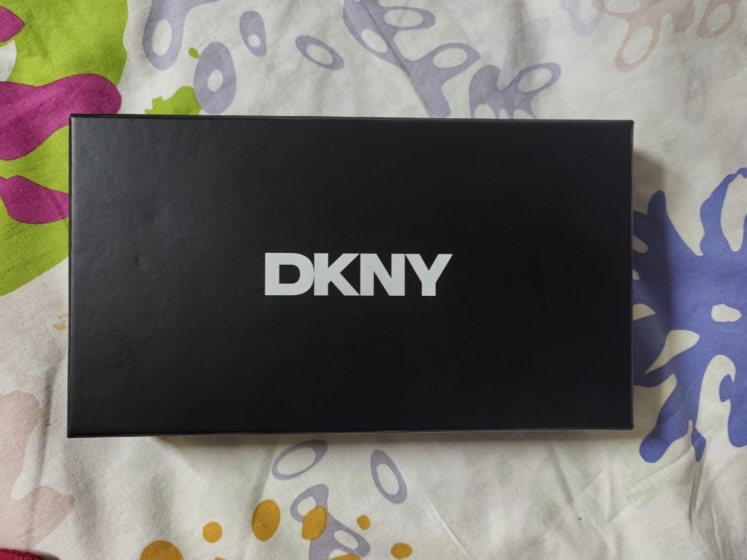 DKNY Black Embossed Logo Zip Around Wallet With Box (Category: Wallets & Card holders) located in Pasay City. Submitted by 3j_shop (Listing ID 1466256029, Image 3). Description: - Brand: DKNY - Color: Classic Black - Design: All-over debossed logo patt ern with front metal logo plate - Hardware: Silver-tone - Closure: Secure zip-around - Condition: Brand new with store tag attached (MSRP $98) - Inclusion: Original black DKNY branded box.