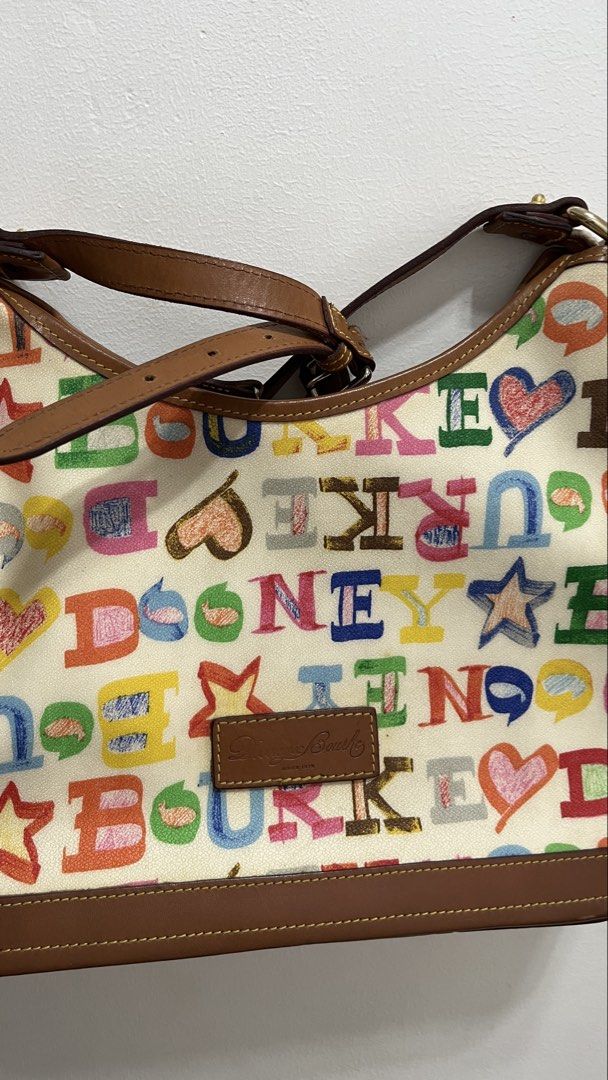 Dooney and Bourke Doodle Collection Hobo Bag (Category: Tote Bags) located in Cavite. Submitted by clarebearxx (Listing ID 1466272500, Image 2). Description: Vintage Dooney & Bourke Doodle Collection hobo shoulder bag featuring a colorful, playful graffiti-style alphabet and heart print on a canvas or coated fabric body with brown leather trim. About the item: 📌 Personal bought by my aunt from Canada Outlet 📌 used item but well taken cared of b