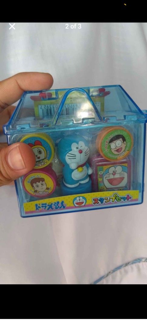 Doraemon Stamp Set Toy House Packaging (Category: Stationery & School Supplies) located in Makati City. Submitted by livelion_c59905 (Listing ID 1466177323, Image 3). Description: - Authentic Japanese Doraemon collectible stamp set from 2004 - Adorable blue house-shaped container with original backing card - Brand new and unopened packaging - Includes character stamps (Doraemon, Nobita, Shizuka, Dorami) - Set also features a mascot figure, memo p