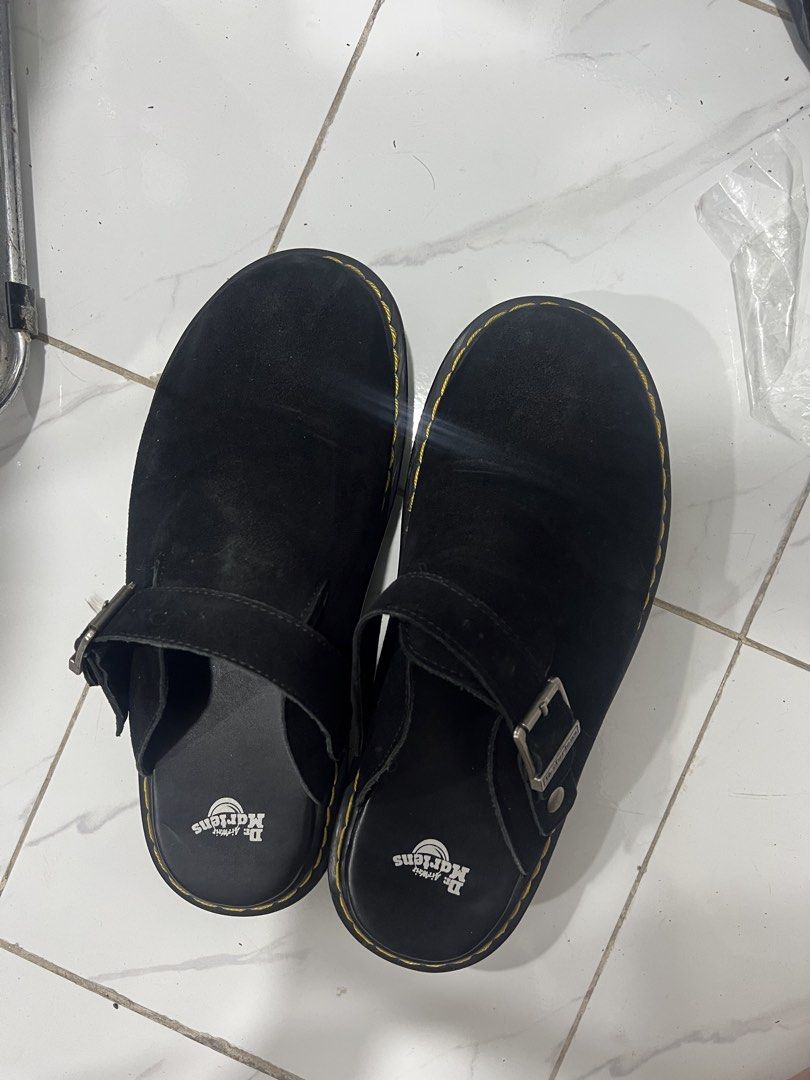 Dr. Martens Black Suede Mules (Category: Flats & Sandals) located in Manila. Submitted by magnuscastle (Listing ID 1466293902, Image 2). Description: - Brand: Dr. Martens - Style: Black suede mules / slip-on - Details: Adjustable strap with metal buckle, classic yellow contrast stitching - Comfort: Padded leather footbed with logo stamp - Sole: Thick grooved sole with very minimal signs of wear - Condition: Clean upper, well-maintained.