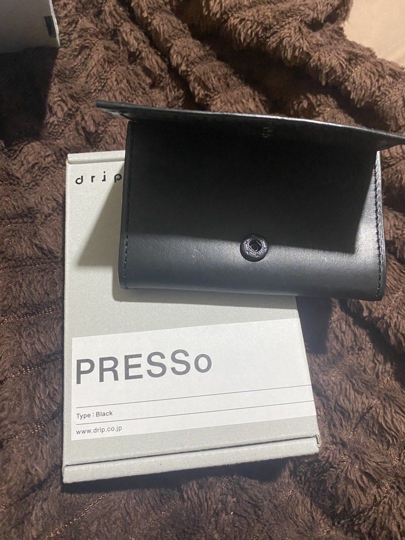 drip PRESSo Black leather wallet (Category: Wallets & Card Holders) located in Manila. Submitted by cdb_22 (Listing ID 1466318485, Image 2). Description: Drip PRESSo wallet in black. Minimalist leather design made for cashless carry. Holds cards, cash, and coins securely with a snap button closure. Comes in the original packaging box with all original inserts and cards included..