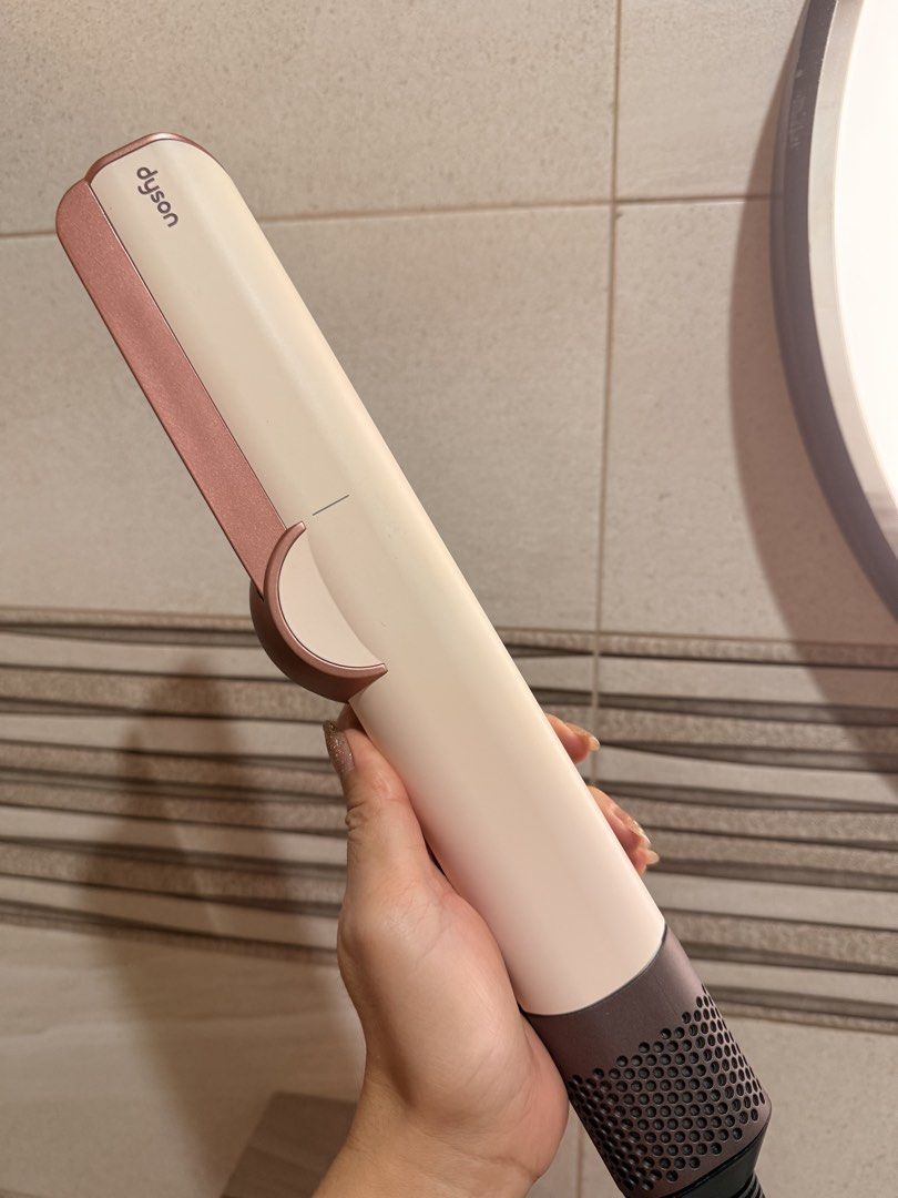Dyson Airstrait ceramic hair styling tool (Category: Hair) located in San Fernando. Submitted by ymnej1201 (Listing ID 1466170453, Image 3). Description: - Authentic Dyson Airstrait Wet-to-Dry Straightener - Color: Ceramic Pink and Rose Gold - Airflow technology dries and straightens simultaneously without hot plates - Digital LCD screen for easy airflow and temperature control - Complete with the bulky PRCD safety plug and built-in instructions 
