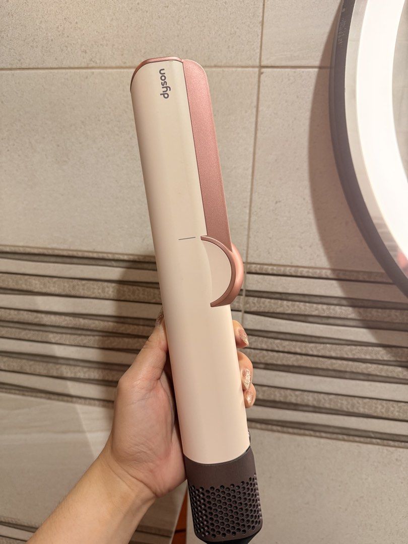 Dyson Airstrait ceramic hair styling tool (Category: Hair) located in San Fernando. Submitted by ymnej1201 (Listing ID 1466170453, Image 2). Description: - Authentic Dyson Airstrait Wet-to-Dry Straightener - Color: Ceramic Pink and Rose Gold - Airflow technology dries and straightens simultaneously without hot plates - Digital LCD screen for easy airflow and temperature control - Complete with the bulky PRCD safety plug and built-in instructions 