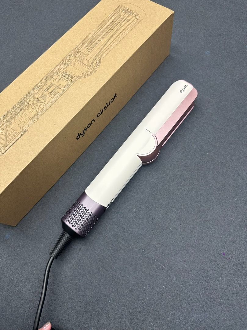 Dyson Airstrait Straightener Ceramic Pop ht01 (Category: Hair) located in Marikina City. Submitted by cosmicdolphin-781db1 (Listing ID 1466181564, Image 1). Description: - Model: Dyson Airstrait (Ceramic Pink & Strawberry Bronze) - Condition: Practically untouched, tested once only - Technology: Dries and straightens simultaneously using airflow, no hot plates, minimizes heat damage - Inclusions: Original brown storage box and matching heat mat -