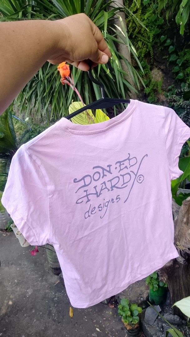 Ed Hardy Pink Dragon Crop Top Size M (Category: Shirts) located in Morong. Submitted by sanjuancla56319 (Listing ID 1466207436, Image 2). Description: - Brand: Ed Hardy - Style: Crop top - Color: Light pink - Design: Blue and yellow dragon graphic with signature script logo on front and back - Size: Medium - Material: Cotton and polyester blend - Care: Machine washable.