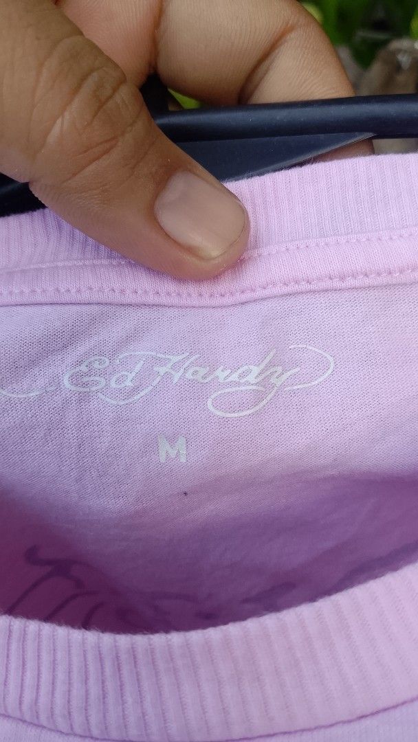 Ed Hardy Pink Dragon Crop Top Size M (Category: Shirts) located in Morong. Submitted by sanjuancla56319 (Listing ID 1466207436, Image 3). Description: - Brand: Ed Hardy - Style: Crop top - Color: Light pink - Design: Blue and yellow dragon graphic with signature script logo on front and back - Size: Medium - Material: Cotton and polyester blend - Care: Machine washable.