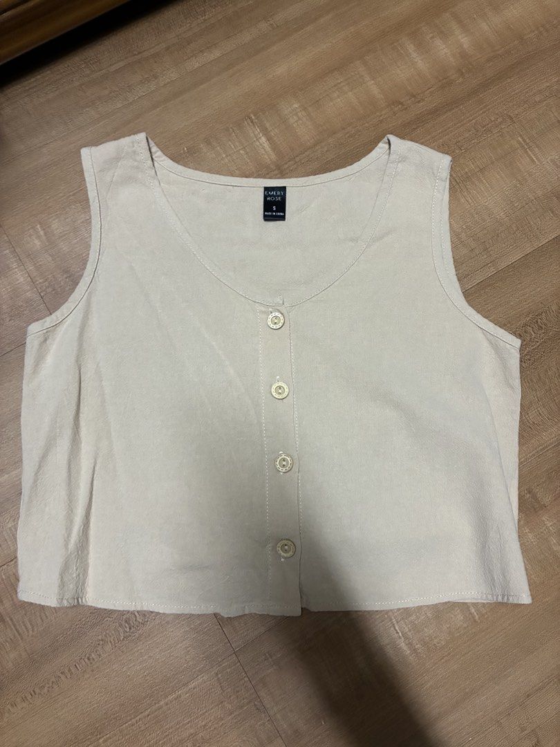 Emery Rose Beige Button Front cropped Tank Top (Category: Sleeveless) located in Quezon City. Submitted by habits.mnl (Listing ID 1466216924, Image 1). Description: - Brand: Emery Rose - Color: Beige - Size: S (tag inside collar) - Design: Scoop neckline with front button closure (four light-colored buttons) - Style: Simple sleeveless, versatile for pairing with jeans or skirts - Origin: Made in China.