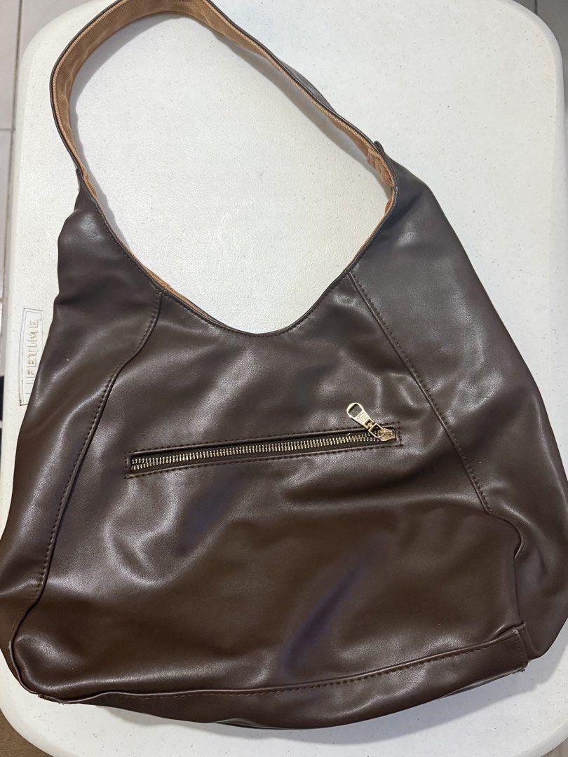 Eve & Adam Reversible Shoulder Bag Brown (Category: Shoulder Bags) located in Makati City. Submitted by louisells (Listing ID 1466183970, Image 2). Description: - Brand: Eve & Adam - Style: Reversible shoulder bag / everyday tote - Side 1: Dark brown faux leather with exterior zip pocket and metal brand badge - Side 2: Brown canvas with exterior zip pocket and metal brand badge - Strap: Comfortable single strap - Features: Two distinct looks in o