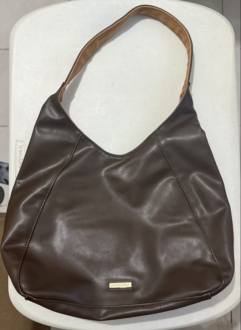 Eve & Adam Reversible Shoulder Bag Brown (Category: Shoulder Bags) located in Makati City. Submitted by louisells (Listing ID 1466183970, Image 1). Description: - Brand: Eve & Adam - Style: Reversible shoulder bag / everyday tote - Side 1: Dark brown faux leather with exterior zip pocket and metal brand badge - Side 2: Brown canvas with exterior zip pocket and metal brand badge - Strap: Comfortable single strap - Features: Two distinct looks in o