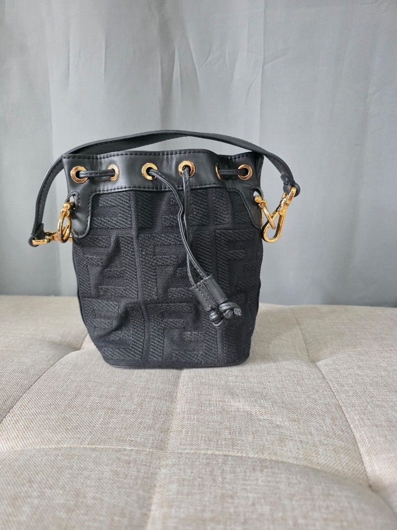 Fendi Mon Tresor Mini Bucket Bag (Category: Luxury Bags & Wallets) located in Binan City. Submitted by karosellescloset (Listing ID 1466311729, Image 1). Description: Fendi Mon Tresor Mini Bucket Bag (in black FF tapestry / woven monogram canvas with gold-tone hardware). ​Key details of this model: ​ ​Material: Black FF logo woven tapestry/canvas with leather trim ​Features: Drawstring closure, gold-finish hardware, detachable leather top handle.