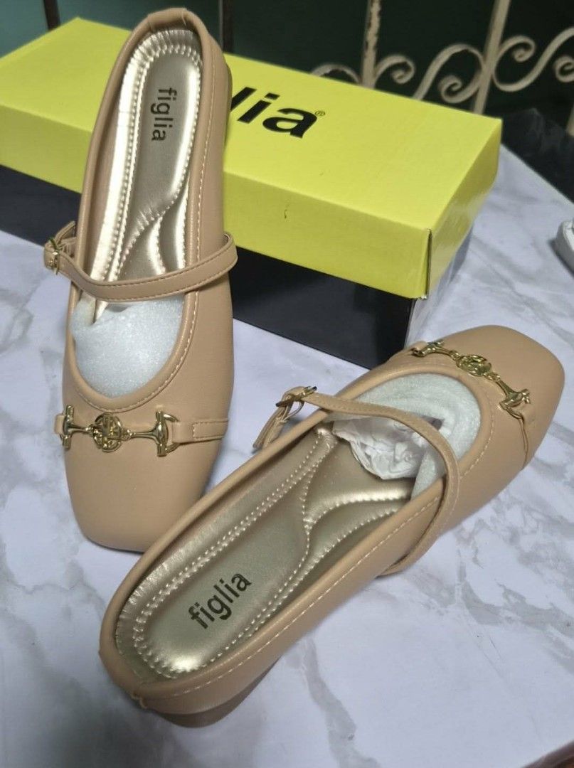 Figlia Beige Mules Flat Shoes with Gold Hardware (Category: Flats & Sandals) located in Manila. Submitted by stuff.gaming (Listing ID 1466209792, Image 1). Description: - Brand: Figlia - Type: Slip-on flat mules - Color: Beige with gold-toned inner sole - Design: Square toe with decorative front gold hardware and thin strap detail - Condition: Excellent, comes with original stuffing paper - Inclusion: Original yellow and black Figlia box Price st