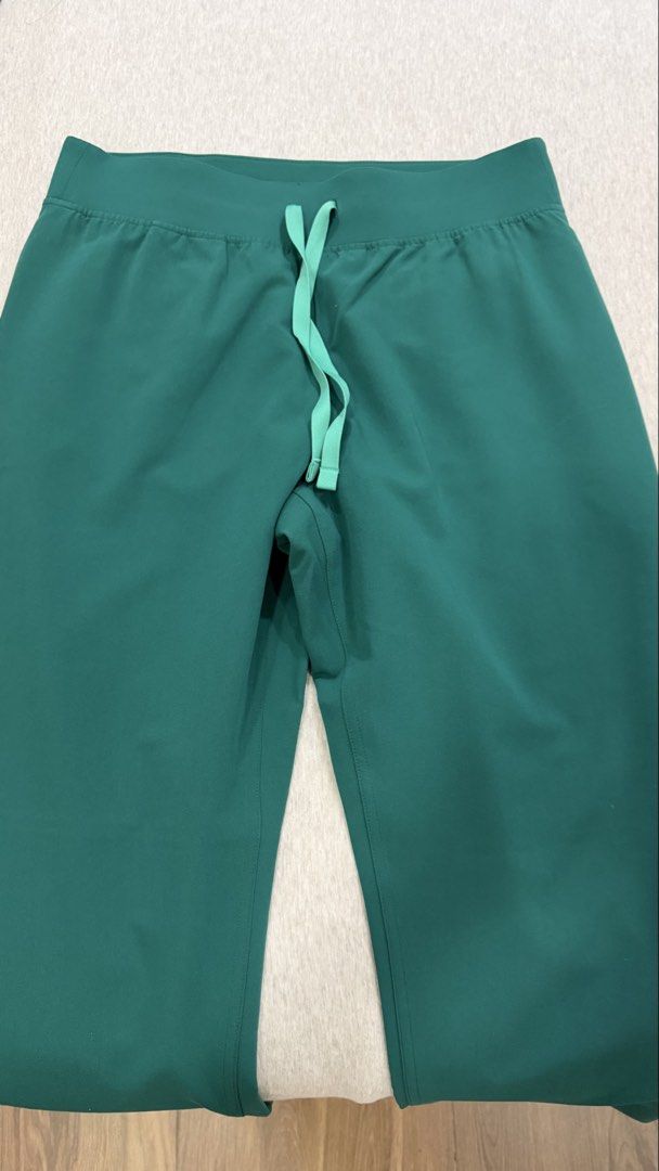 FIGS Livingston Scrub Pants Hunter Green (Medium Petite) (Category: Activewear) located in Quezon City. Submitted by prelovedbyncy (Listing ID 1466289949, Image 2). Description: - Brand/Style: FIGS Livingston Scrub Pants - Color: Green - Size: Medium Petite (M/P) - Material: Soft stretch blend of polyester, rayon, and spandex - Features: Drawstring waistband and back pocket with embroidered FIGS logo - Condition: fitted only, too big on me. Clean
