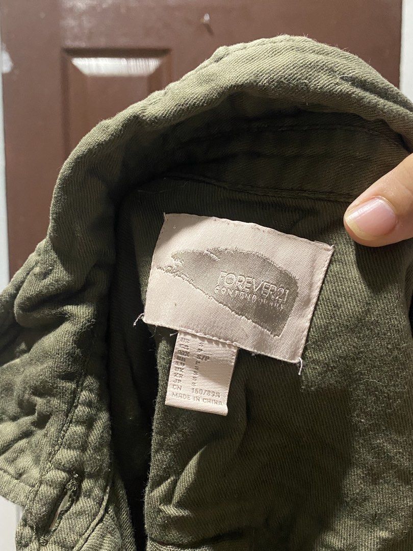 Forever 21 Green Utility Jacket Size S (Category: Coats, Jackets and Outerwear) located in Calamba. Submitted by soleilcollections.ph (Listing ID 1466237322, Image 2). Description: - Brand/Line: Forever 21 Contemporary - Color: Olive Green - Size: S (160/84A) - Design: Button-down front, standard collar, long sleeves with button cuffs - Pockets: Two functional chest pockets - Hem: High-low design (shorter front, longer back) - Origin: Made in Chi