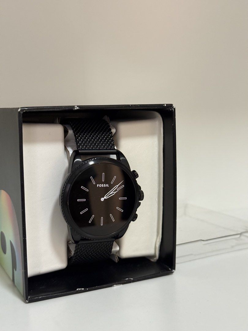 Fossil Gen 6 Smartwatch Black Mesh Strap DW13F2 (Category: Wearables & Smart Watches) located in Pasig City. Submitted by eiramcat01 (Listing ID 1466244539, Image 1). Description: - Brand: Fossil Smartwatch - Color: All-black case with matching black mesh metal strap - Display: Digital display inside a classic round dial - Features: Built-in heart rate sensor and 3-button navigation - Strap: Standard quick-release pins for easy strap swapping - I