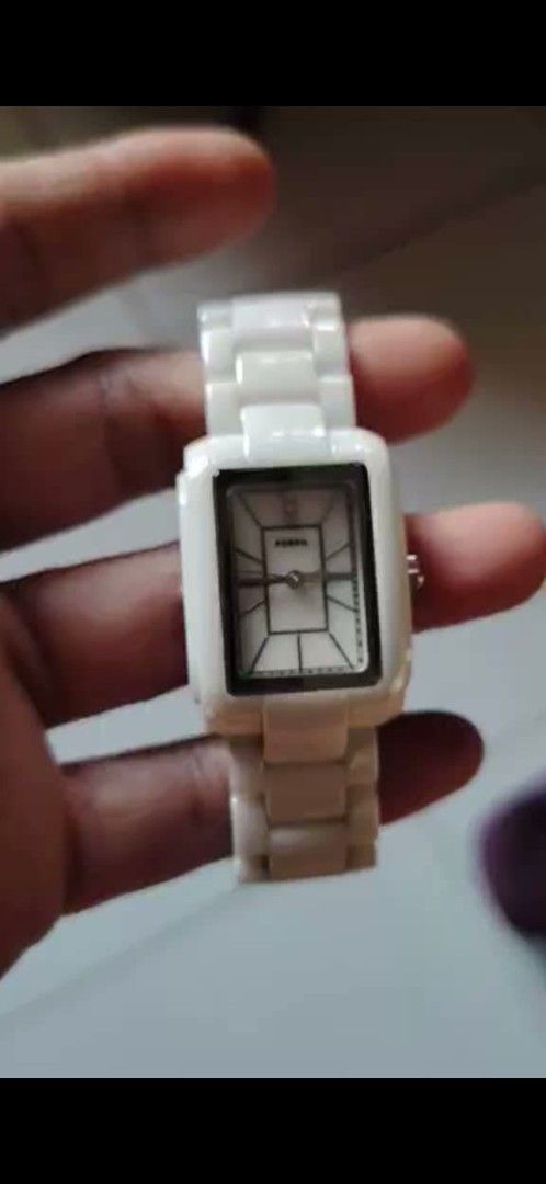 Fossil White Ceramic Rectangle Analog Watch (Category: Women's Watches) located in Manila. Submitted by analiepagl91301 (Listing ID 1466303670, Image 1). Description: - Brand: Fossil - Material: Clean white ceramic finish - Dial: Rectangular with black markers and top crystal accent - Closure: Link bracelet with Fossil-engraved fold-over clasp - Style: Versatile for everyday use or evening wear - Condition: Excellent.
