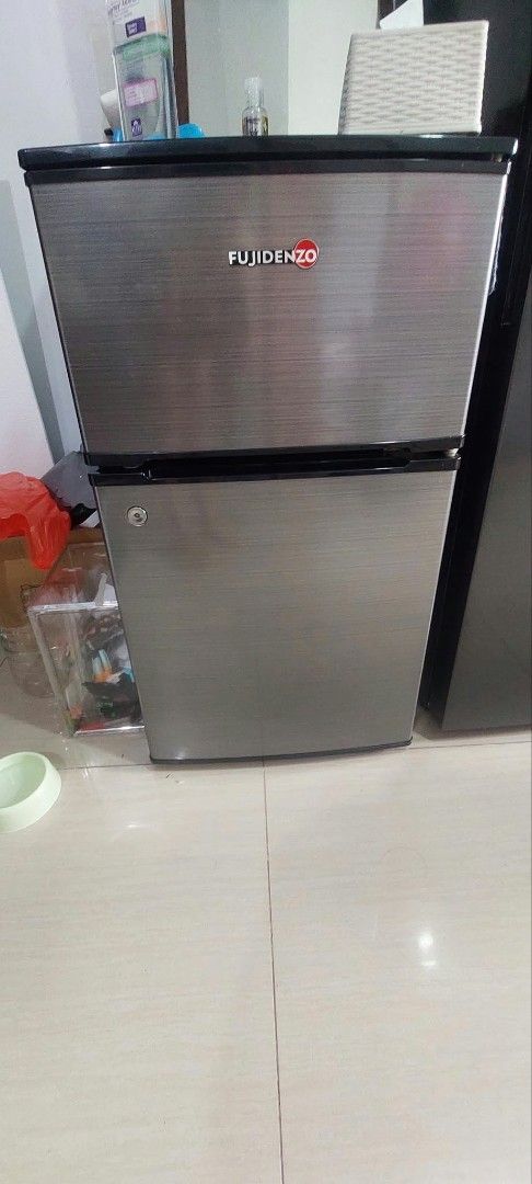 Fujidenzo Mini Refrigerator Two Door Silver (Category: Refrigerators and Freezers) located in Makati City. Submitted by bazzinga73 (Listing ID 1466186507, Image 2). Description: - Brand/Model: Fujidenzo 2-Door Mini Refrigerator - Color: Stylish brushed silver finish - Layout: Top freezer compartment and lower fridge section - Interior: Durable glass shelves, crisper drawer, and convenient door bins - Ideal For: Small spaces, dorm rooms, and offic