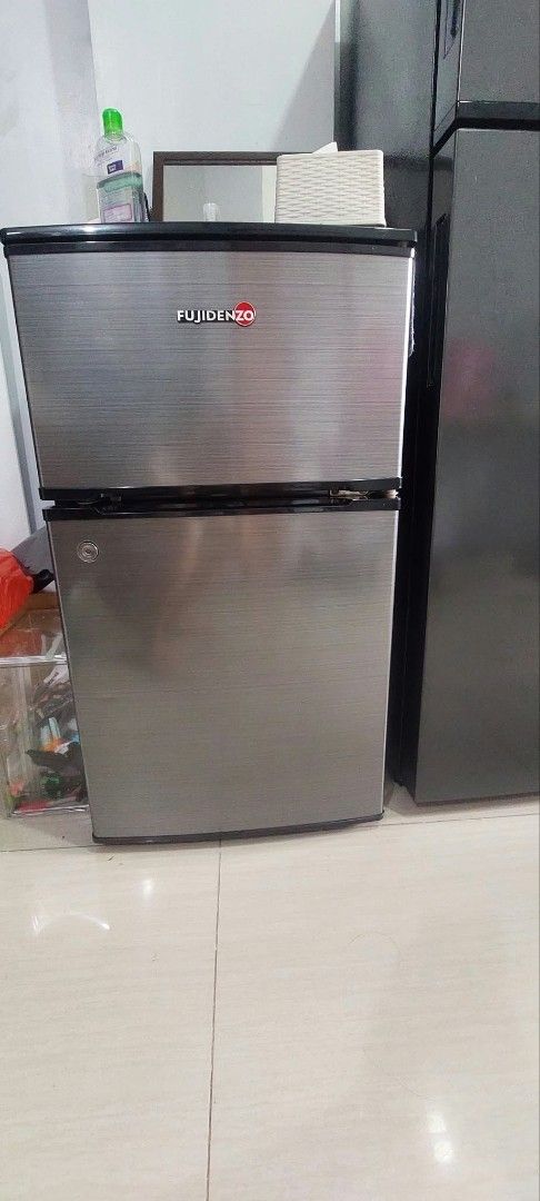 Fujidenzo Mini Refrigerator Two Door Silver (Category: Refrigerators and Freezers) located in Makati City. Submitted by bazzinga73 (Listing ID 1466186507, Image 1). Description: - Brand/Model: Fujidenzo 2-Door Mini Refrigerator - Color: Stylish brushed silver finish - Layout: Top freezer compartment and lower fridge section - Interior: Durable glass shelves, crisper drawer, and convenient door bins - Ideal For: Small spaces, dorm rooms, and offic
