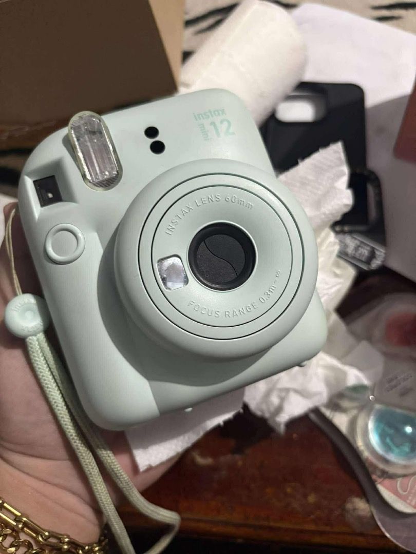 Fujifilm Instax Mini 12 Pastel Blue Bundle With Accessories (Category: Cameras) located in Roxas City. Submitted by trixxxxxxx (Listing ID 1466260632, Image 1). Description: - Authentic Fujifilm Instax Mini 12 in Pastel Blue - Complete bundle: includes matching hand strap - Includes 4-filter colored lens set for creative shots - Comes with assorted decorative patches and stickers - Includes a photo-replaceable storage frame - Fully functional, te
