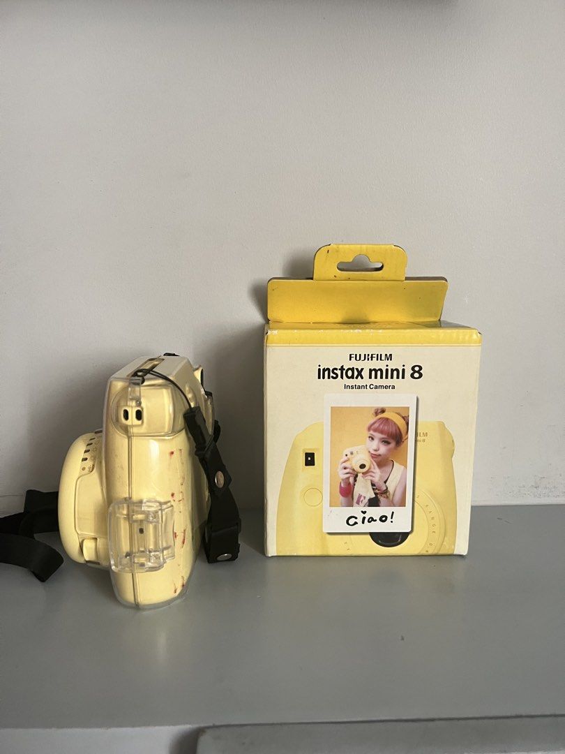 Fujifilm Instax Mini 8 Yellow Instant Camera with Case (Category: Cameras) located in Quezon City. Submitted by liz.ty (Listing ID 1466227188, Image 2). Description: - Model: Fujifilm Instax Mini 8 in vibrant yellow - Condition: Camera body is clean; original box has minor shelf wear - Includes: Original box and Caiul clear protective case with strap - Features: Fun, retro, and super easy to operate - Perfect for: Parties, trips, and everyday sna