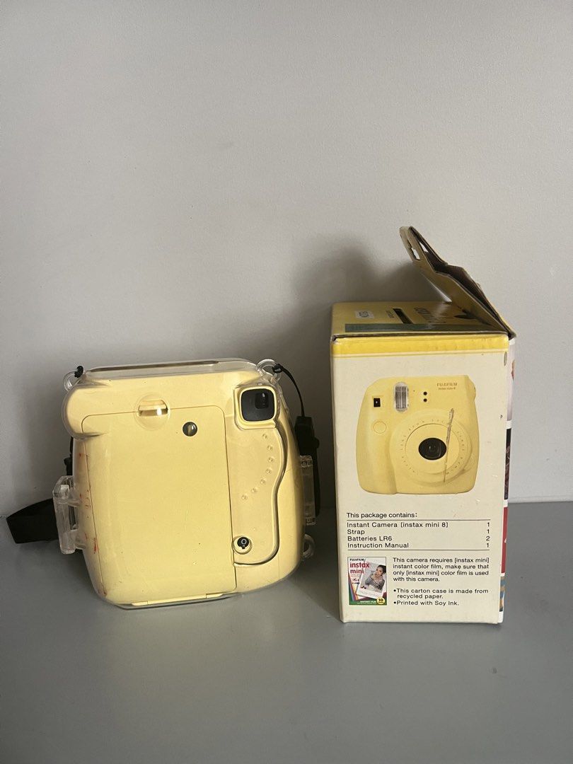 Fujifilm Instax Mini 8 Yellow Instant Camera with Case (Category: Cameras) located in Quezon City. Submitted by liz.ty (Listing ID 1466227188, Image 3). Description: - Model: Fujifilm Instax Mini 8 in vibrant yellow - Condition: Camera body is clean; original box has minor shelf wear - Includes: Original box and Caiul clear protective case with strap - Features: Fun, retro, and super easy to operate - Perfect for: Parties, trips, and everyday sna