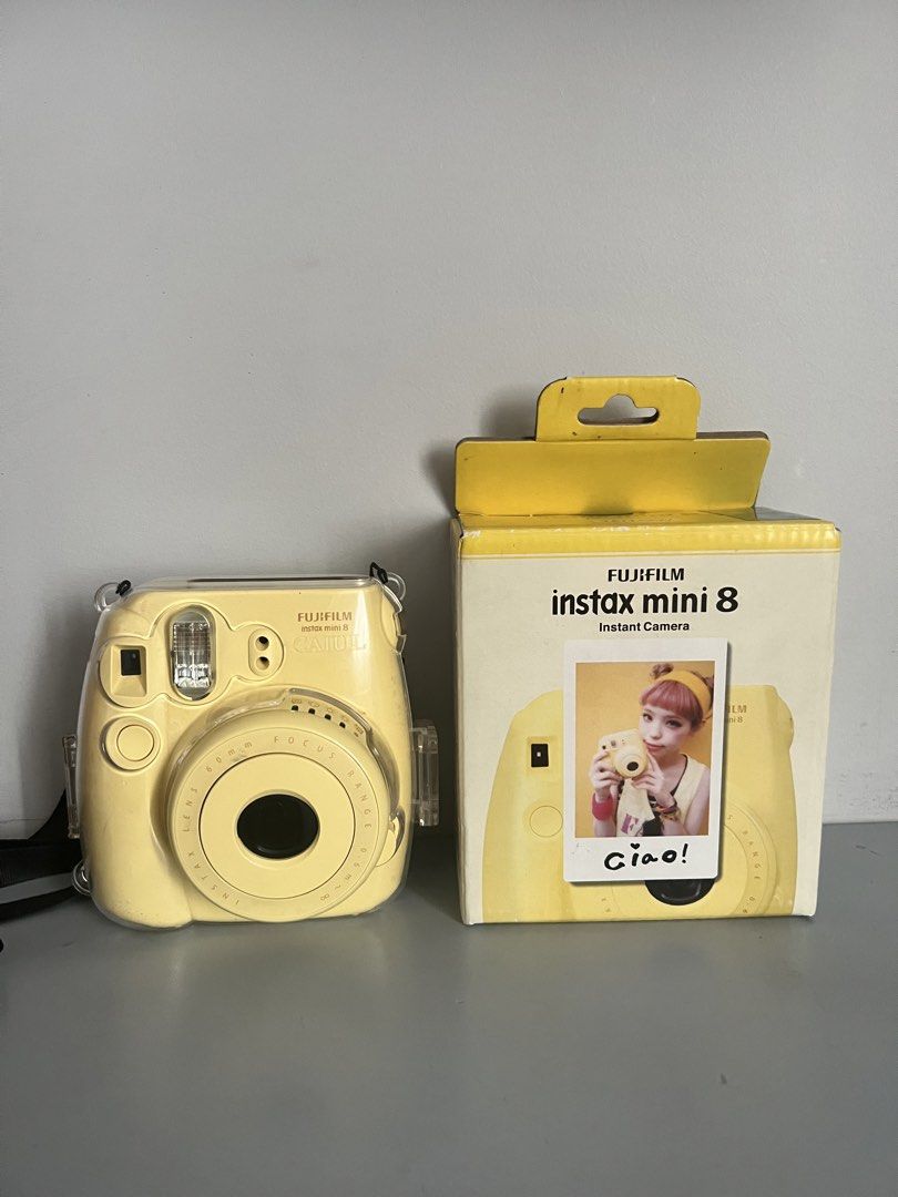 Fujifilm Instax Mini 8 Yellow Instant Camera with Case (Category: Cameras) located in Quezon City. Submitted by liz.ty (Listing ID 1466227188, Image 1). Description: - Model: Fujifilm Instax Mini 8 in vibrant yellow - Condition: Camera body is clean; original box has minor shelf wear - Includes: Original box and Caiul clear protective case with strap - Features: Fun, retro, and super easy to operate - Perfect for: Parties, trips, and everyday sna