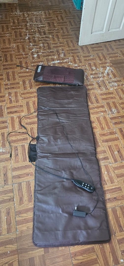Full Body Massage Mat with Wired Remote and Pillow (Category: Massage Devices) located in Manila. Submitted by anthonylee23810 (Listing ID 1466298078, Image 3). Description: - Brown full body massage mat with separate matching pillow - Wired handheld controller for easy operation - Multiple vibration intensity settings and soothing heat options - Plugs directly into standard wall outlets (adapter included) - Ideal for back pain relief, relaxation