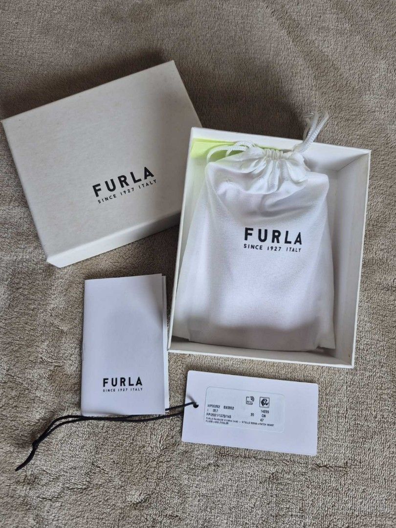 Furla Rainbow Heart Leather Card Holder (Category: Wallets & Card holders) located in Antipolo. Submitted by mfbien_ownpreloved (Listing ID 1466191713, Image 2). Description: Bright pink leather card holder by Furla. Features an embroidered rainbow heart patch on the front with "LOVE" . Multiple card slots on both sides. Silver-toned Furla logo stamped on the back. Includes original dust bag, tags, care booklet, and branded storage box. Price sli