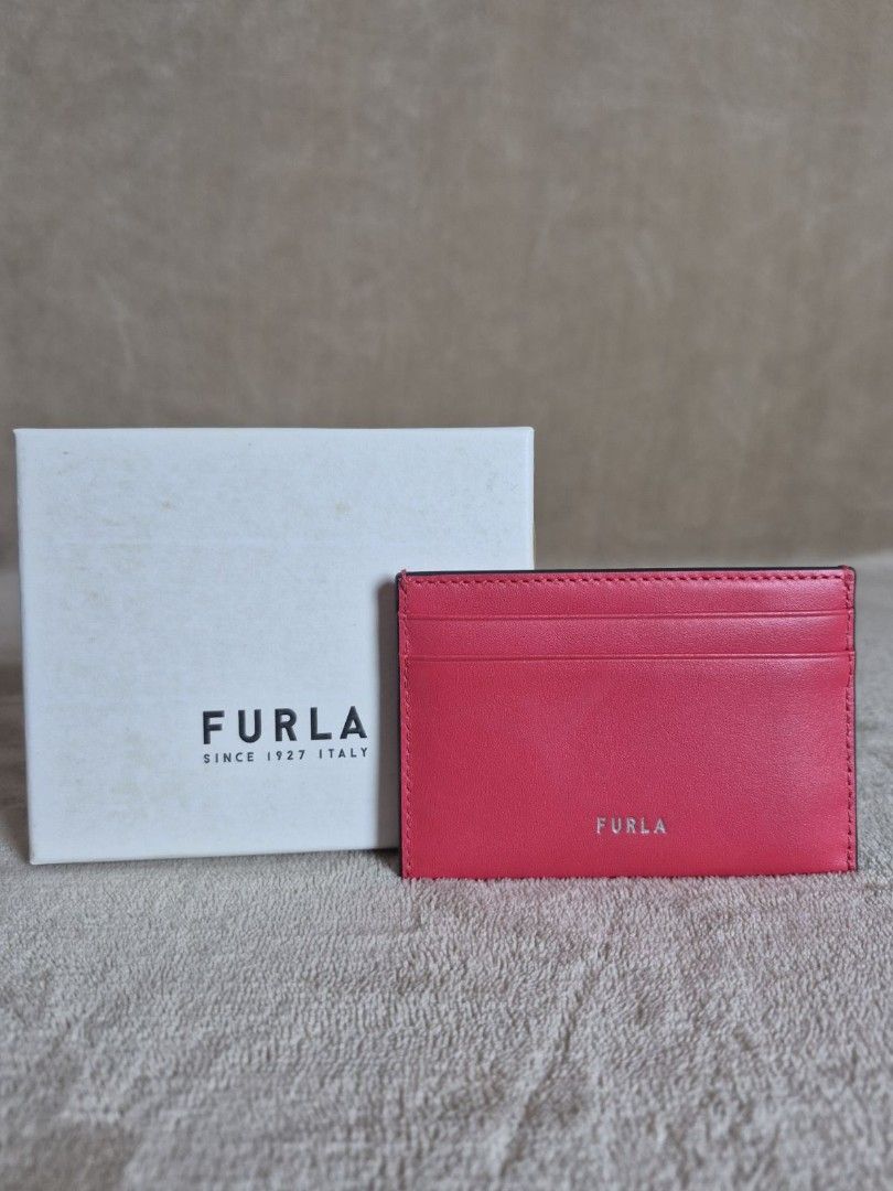 Furla Rainbow Heart Leather Card Holder (Category: Wallets & Card holders) located in Antipolo. Submitted by mfbien_ownpreloved (Listing ID 1466191713, Image 3). Description: Bright pink leather card holder by Furla. Features an embroidered rainbow heart patch on the front with "LOVE" . Multiple card slots on both sides. Silver-toned Furla logo stamped on the back. Includes original dust bag, tags, care booklet, and branded storage box. Price sli