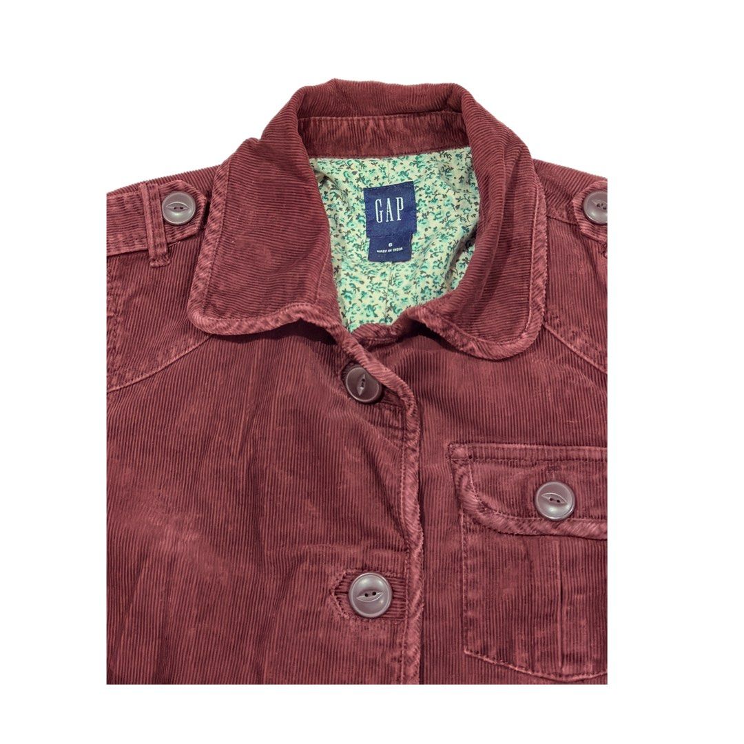 Gap Maroon Corduroy Jacket (Category: Coats, Jackets and Outerwear) located in Santa Rosa. Submitted by cmasangkay (Listing ID 1466229595, Image 3). Description: - Brand/Style: Gap maroon corduroy jacket - Size: 6 (tagged on collar) - Features: Button-up front, multiple chest and lower utility pockets, and button cuffs - Details: Beautiful green floral inner lining, classic structured fit - Origin: Made in India - Condition: Excellent pre-loved c