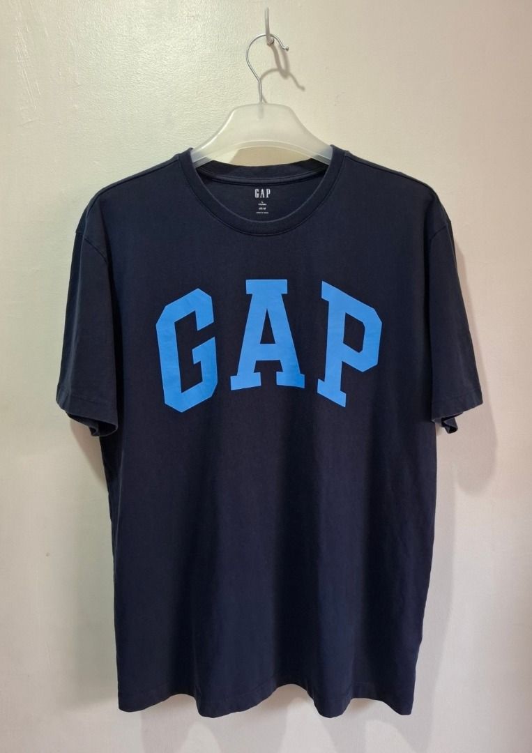GAP Navy Blue Logo T-Shirt (Category: Tshirts & Polo Shirts ) located in Bulacan. Submitted by kei.collections (Listing ID 1466312465, Image 1). Description: - Brand: GAP - Color: Dark blue with light blue graphic print -Color Rate: 9.5//10 - Size: US L/G/EG - Material: 100% cotton (machine washable) - Fit: Short sleeves, crew neck - Condition: 10/10 - Issue: None - Mode of Payment: GCash - Shipping: via J&T Express (Metro Manila & Provincial).