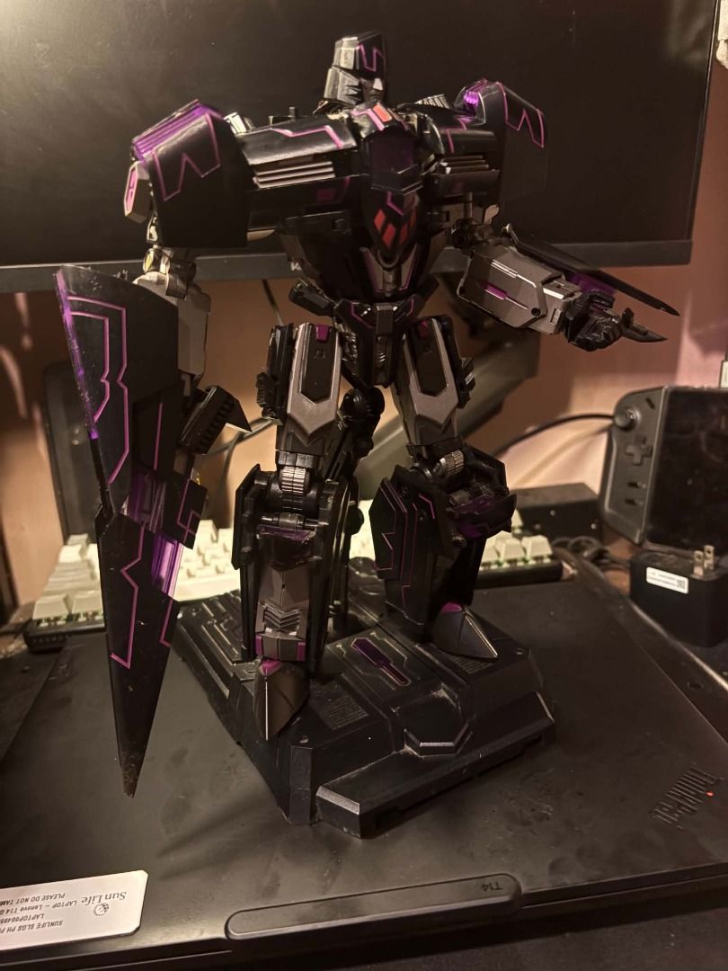 Generation Toy GT-02 Tyrant IDW (B2 bomber megatron) - 3rd parTy (Category: Figurines & Statues) located in Taguig. Submitted by livehorse.8cf1df (Listing ID 1466294749, Image 3). Description: - Custom black and purple colorway - Includes a matching dark display stand - Detailed robotic sculpt with sharp shoulder armor - Built-in arm cannon feature - Solid build with metallic paint accents - Excellent display piece for collectors.