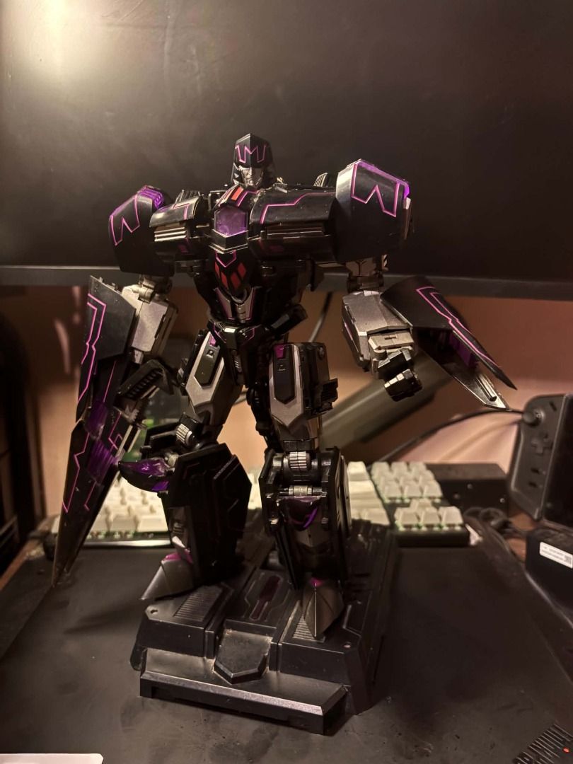 Generation Toy GT-02 Tyrant IDW (B2 bomber megatron) - 3rd parTy (Category: Figurines & Statues) located in Taguig. Submitted by livehorse.8cf1df (Listing ID 1466294749, Image 1). Description: - Custom black and purple colorway - Includes a matching dark display stand - Detailed robotic sculpt with sharp shoulder armor - Built-in arm cannon feature - Solid build with metallic paint accents - Excellent display piece for collectors.