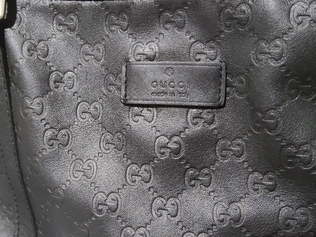 GG Monogram Tote Bag (Category: Luxury Bags & Wallets) located in Cebu City. Submitted by almzcorner (Listing ID 1466302782, Image 2). Description: - Brand: Gucci - Material: Premium black leather with debossed GG monogram pattern - Handles: Dual top handles in black leather with metal hardware - Design: Open top with patterned fabric interior lining and structured base - Capacity: Spacious interior, perfect for daily essentials - Condition: Exce