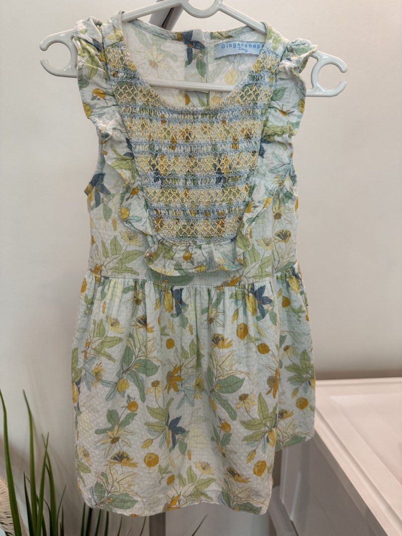Gingersnaps Tiny Floral Dress Size 24M (Category: Babies & Kids Fashion) located in Quezon City. Submitted by actank (Listing ID 1466178886, Image 1). Description: - Brand: Gingersnaps - Size: 24 months - Color/Pattern: Light blue and green with all-over botanical print - Details: Smocked bodice with yellow stitching, ruffled cap sleeves, and back button closure - Condition: Excellent pre-loved condition - Perfect for daily wear or special occasi