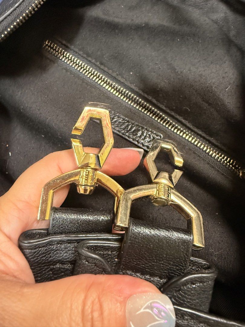 Givenchy Black Leather Tote Handbag (Category: Tote Bags) located in Manila. Submitted by rrtolibas48132 (Listing ID 1466283119, Image 3). Description: Black grained leather tote from Givenchy. Dual top handles and gold-tone hardware. Zip closure across the top. Fabric interior lining with an interior zip pocket and leather brand patch. Includes strap with gold lobster clasps. Roomy everyday bag..