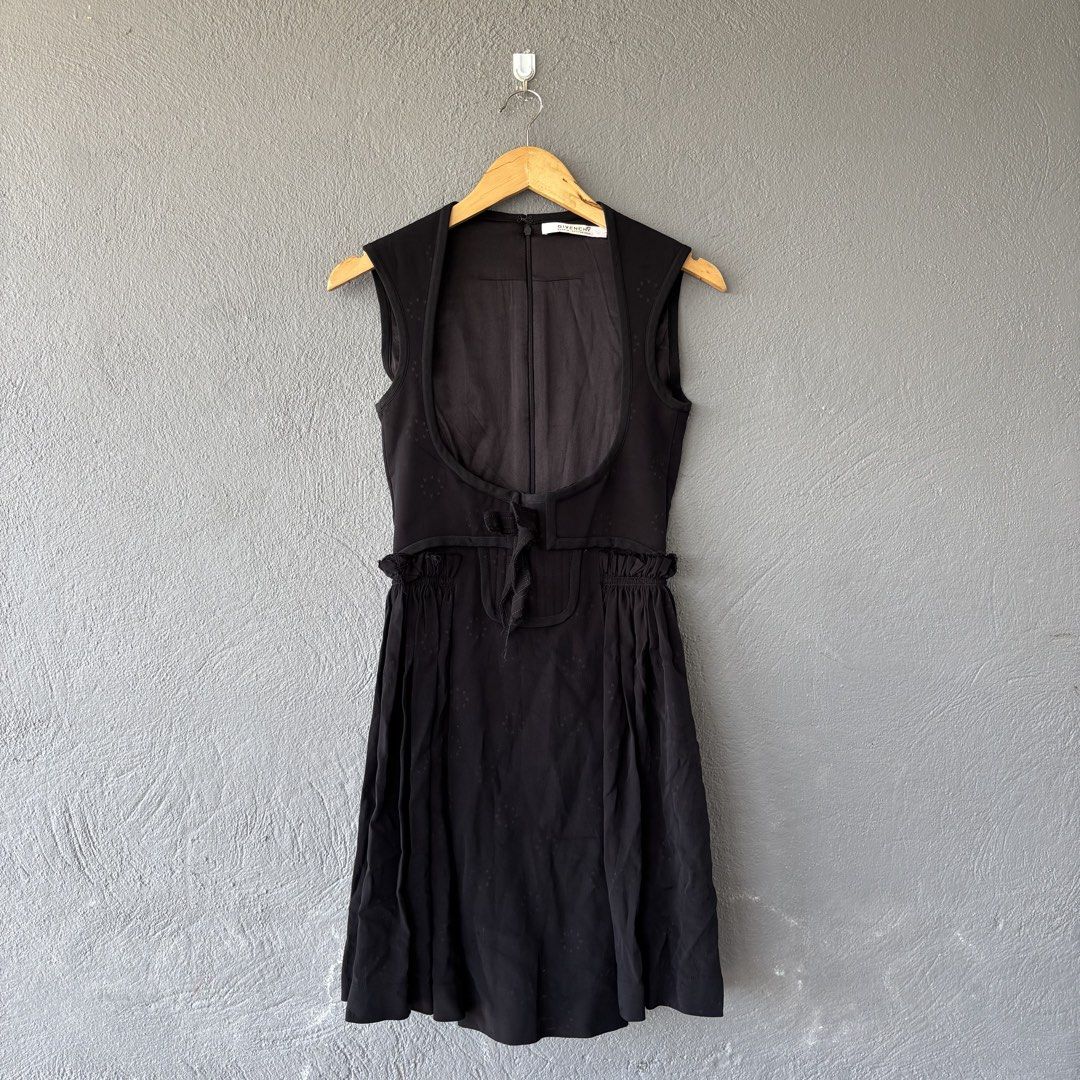 Givenchy Sample Black Sleeveless Dress with Star Pattern (Category: Dresses) located in San Fernando. Submitted by diff.thr1ft (Listing ID 1466169916, Image 1). Description: - Brand: Givenchy - Condition: Sample piece with original tag attached - Color: Black with subtle tonal woven star pattern - Style: Sleeveless dress with open-front vest-like overlay and waist tie - Silhouette: Gathered flared skirt - Closure: Back zipper with hook and eye at