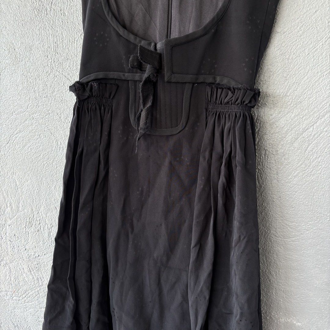 Givenchy Sample Black Sleeveless Dress with Star Pattern (Category: Dresses) located in San Fernando. Submitted by diff.thr1ft (Listing ID 1466169916, Image 2). Description: - Brand: Givenchy - Condition: Sample piece with original tag attached - Color: Black with subtle tonal woven star pattern - Style: Sleeveless dress with open-front vest-like overlay and waist tie - Silhouette: Gathered flared skirt - Closure: Back zipper with hook and eye at